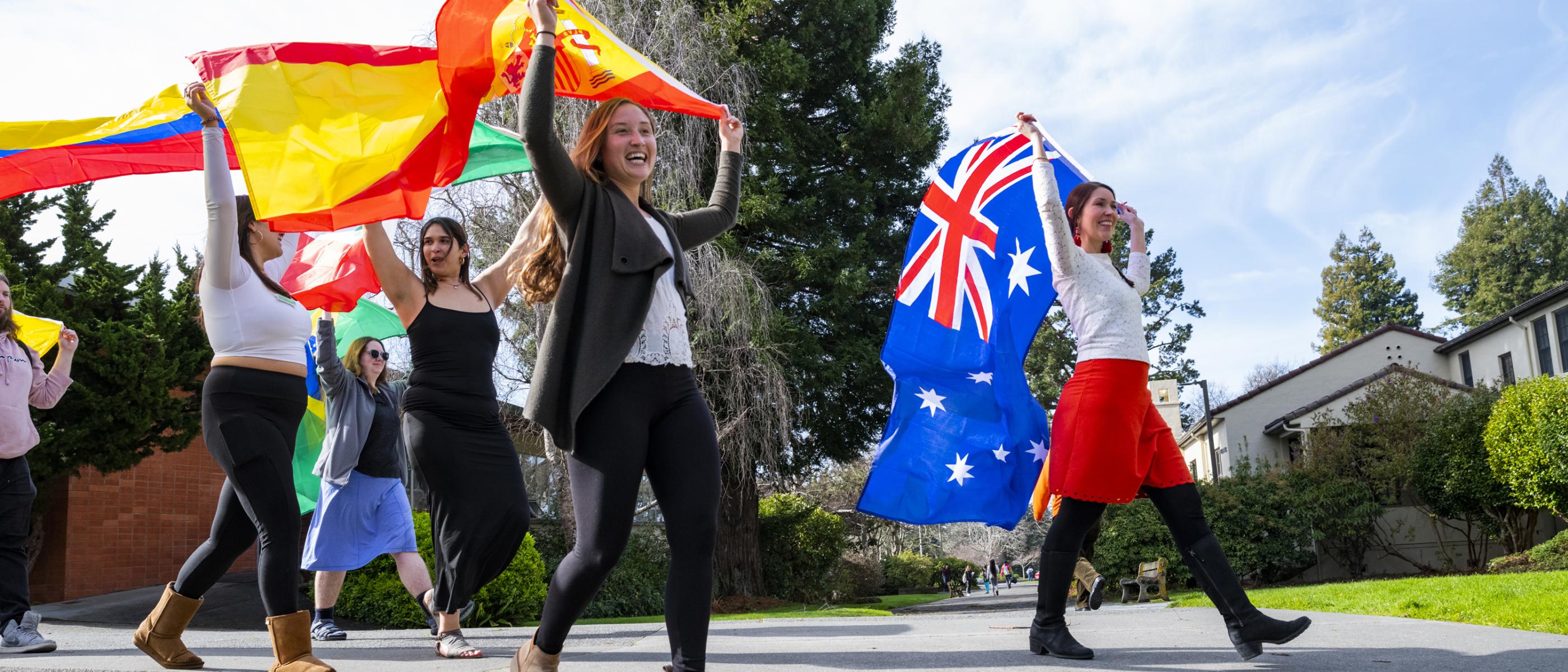 Cal Poly Humboldt International students carrying flags of their countries