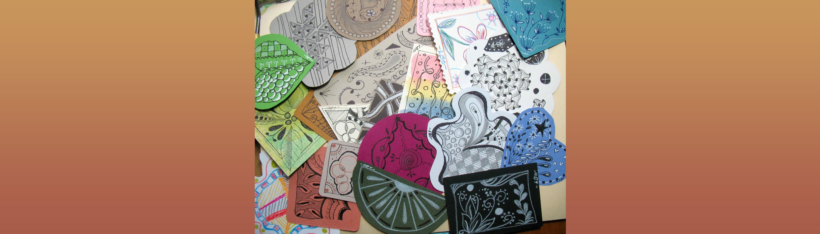 Small pieces of paper art with hand-drawn decorative designs