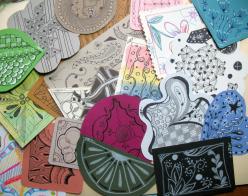 Small pieces of paper art with hand-drawn decorative designs